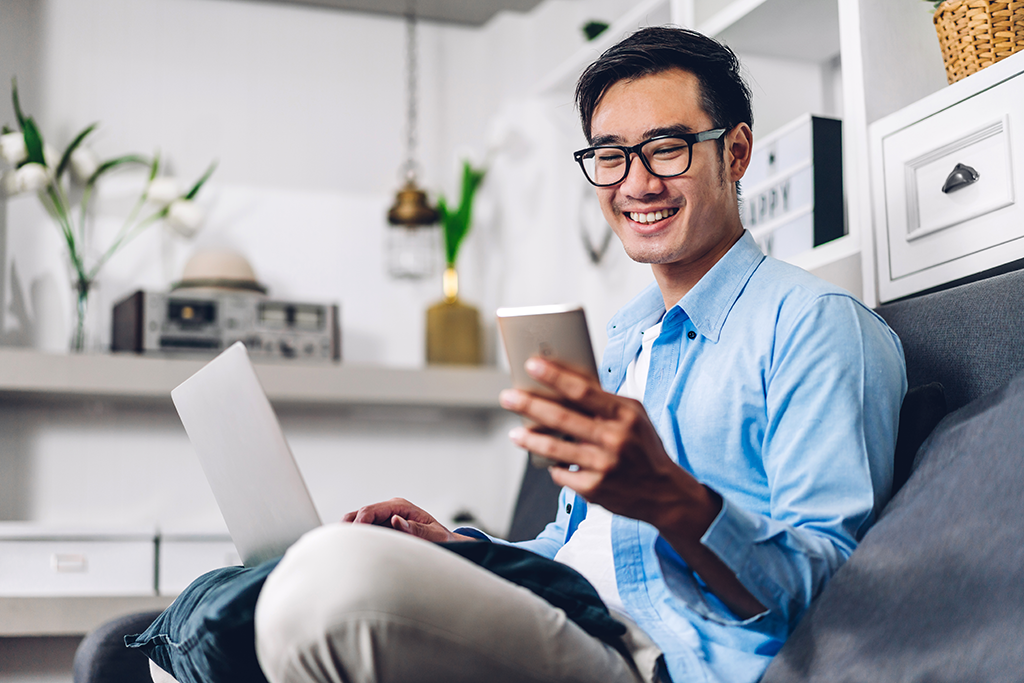 Smiling Asian man on mobile phone