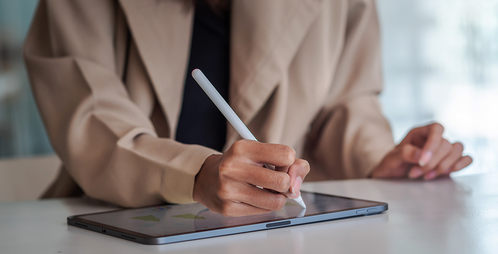 hands signing on tablet