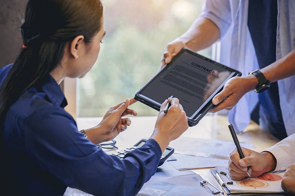 Woman using tablet to sign