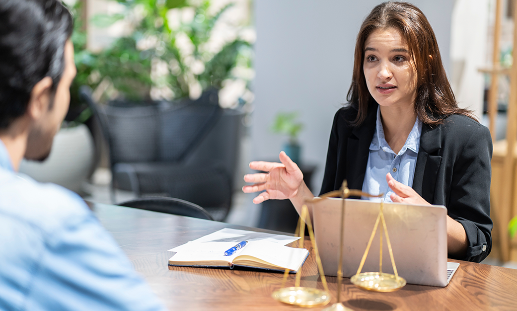 woman lawyer with laptop and justice scales