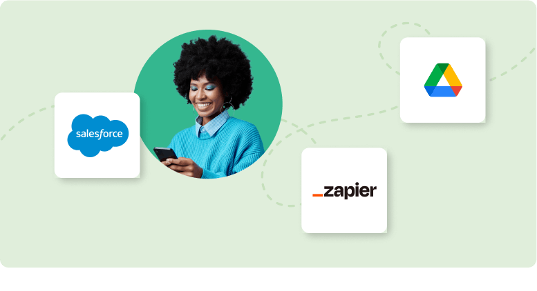 Woman smiling at cellphone with Salesforce, Google Drive, and Zapier logos around her
