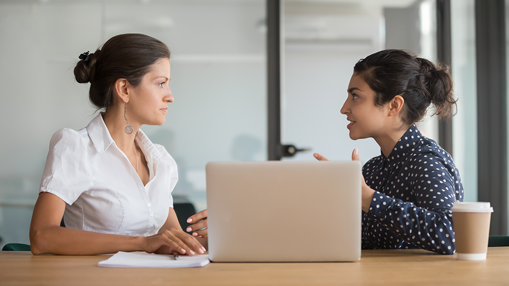 two women excitedly talking