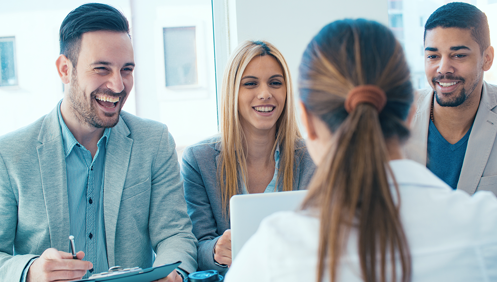 group of smiling happy employees meeting with HR representative